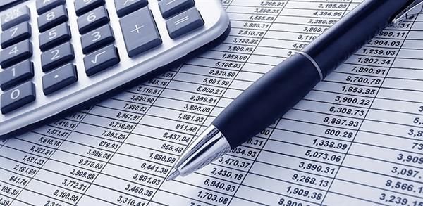 Photo of calculator, pen, and spreadsheet Photo of calculator, pen, and spreadsheet